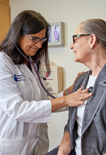 Doctor checking patient's heartbeat